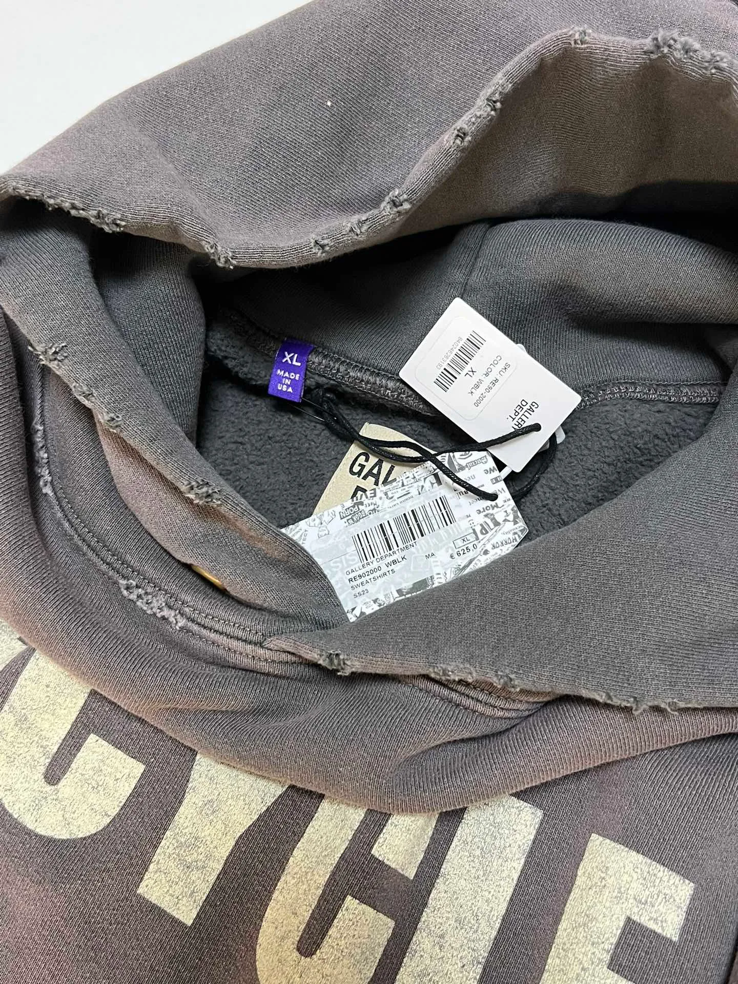 GALLERY DEPT. 90'S RECYCLE HOODIE WASHED BLACK 90'S washed hoodie with distressed eco-friendly slogans. Washed black S-XL. Ready-made garments are washed and dyed again. Multiple spots throughout the body are spray-faded. The ribs are cut and worn.